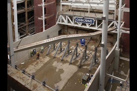 These pictures show the process of craning in the 18m precast beams that now support the 400-seat lecture theatre roof
